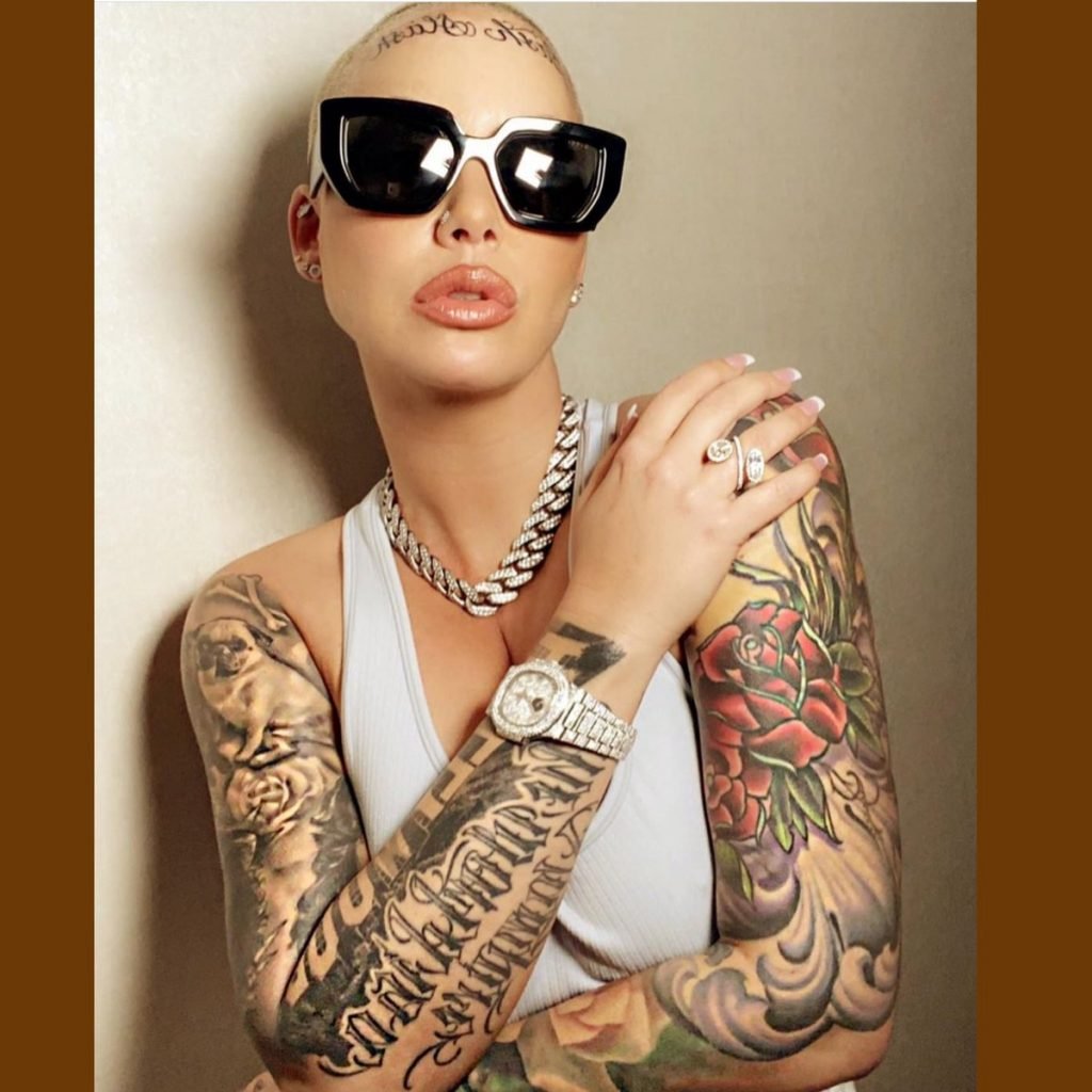 Amber Rose Tattoos; The Slash, Flowers Tattoo and Forehead Tattoo